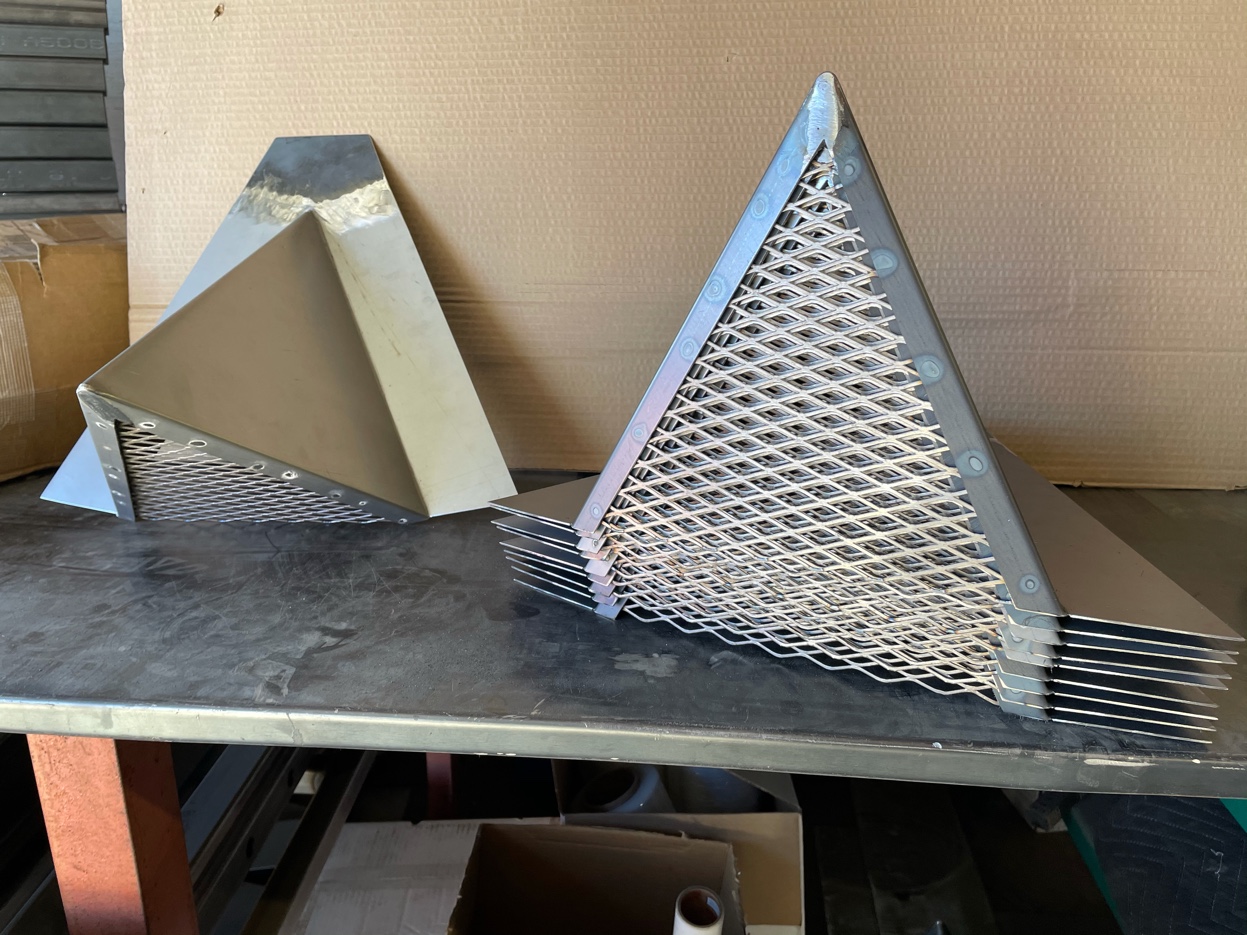 Batch of chimney caps in progress on the workbench at Pro Form Metals
