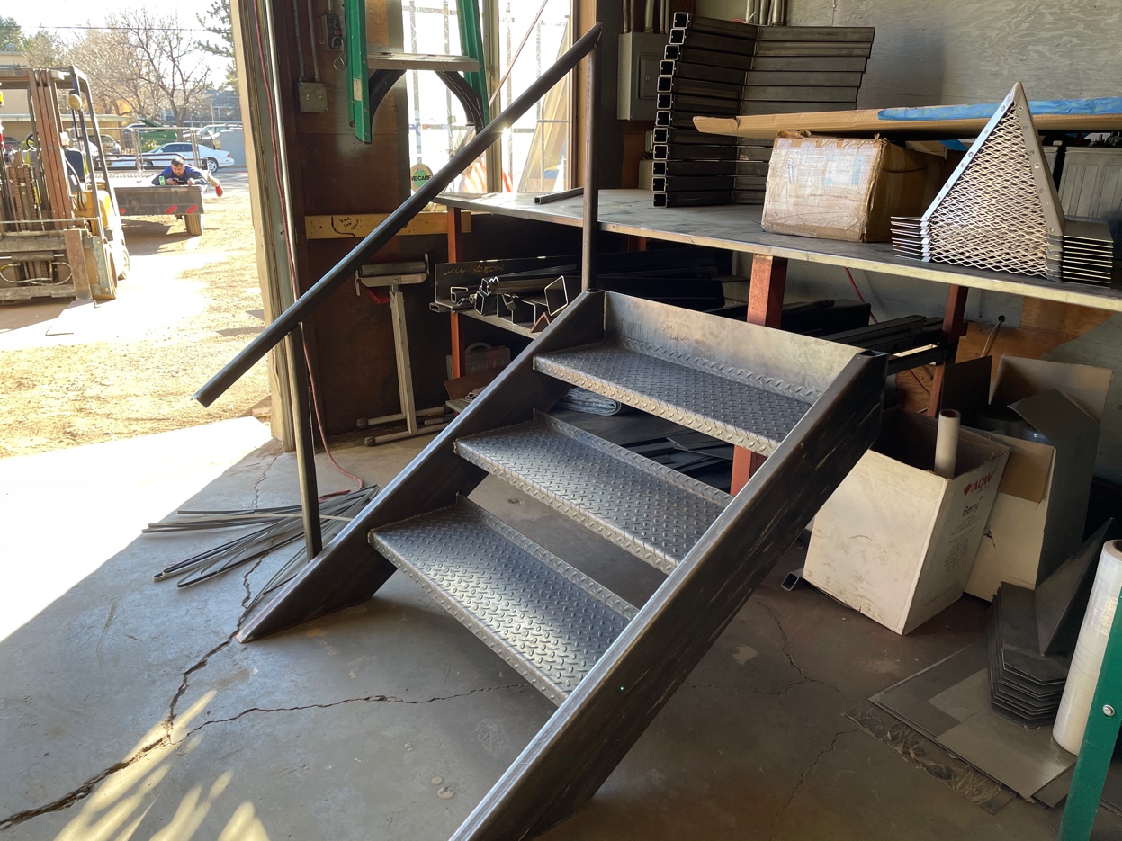 Custom steel stairs with diamond plate treads and railing