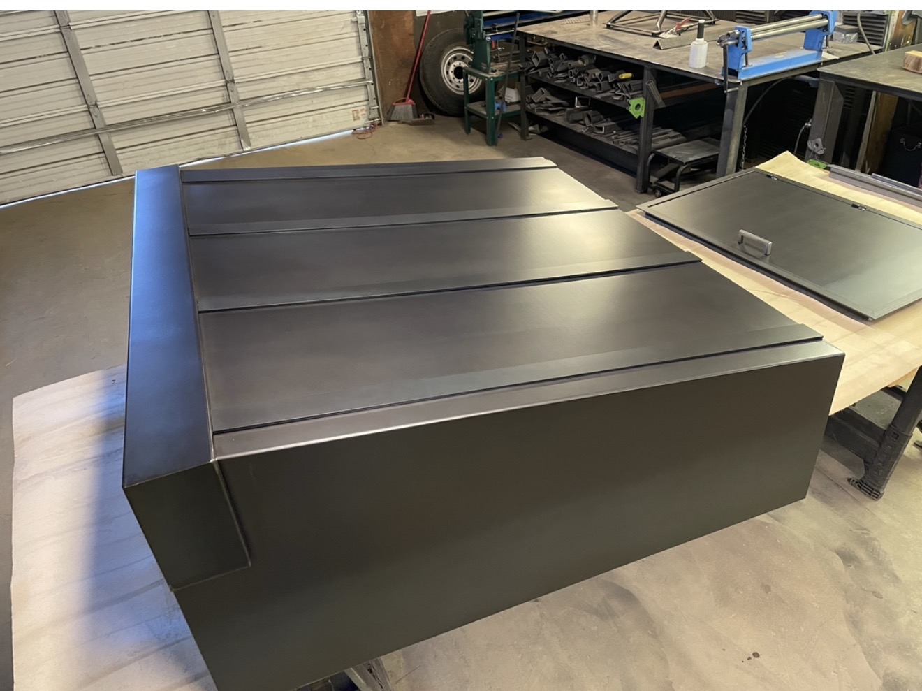 Matte black range hood with panel seams