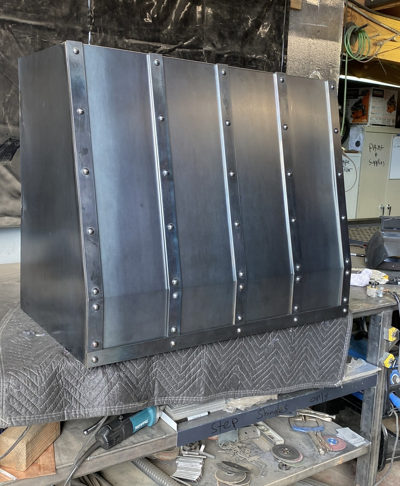 Riveted steel range hood in fabrication